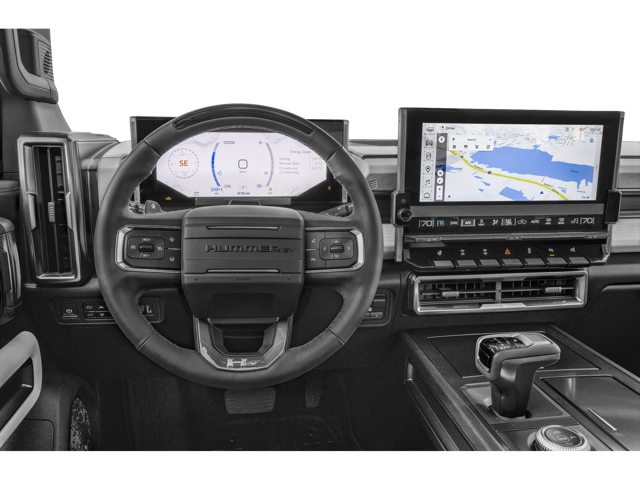 Close up view of 2026 GMC Hummer EV Pickup front dashboard from the drivers point of view. Steering wheel, temperature controls, gear shift and touch screen are visible.