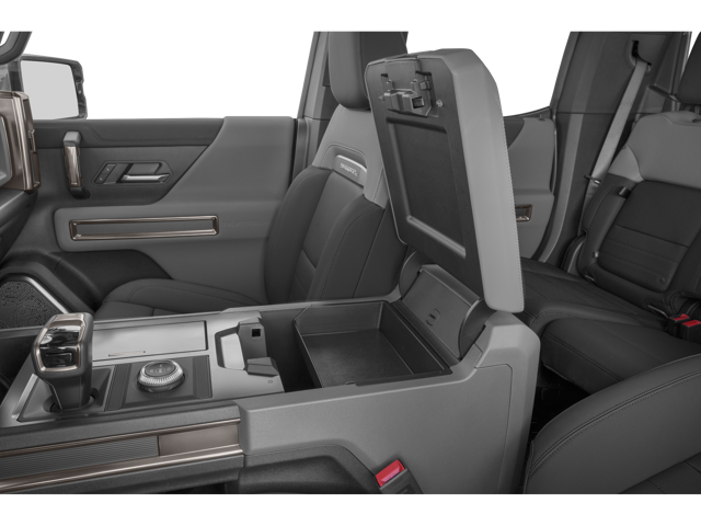 Interior view of 2026 GMC Hummer EV Pickup's open center console and front two seats