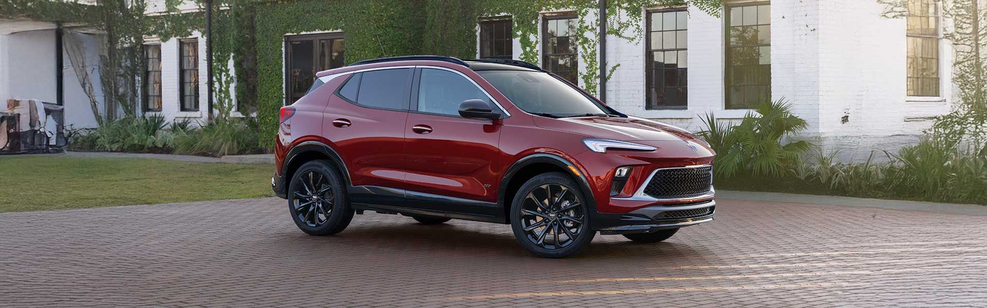 Side view of 2025 Buick Encore GX on a large brick driveway