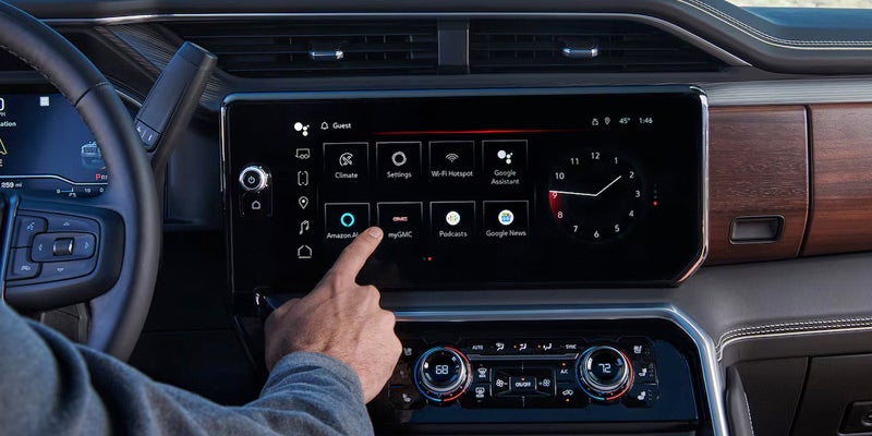 Close up view of driver interacting with dashboard touch screen