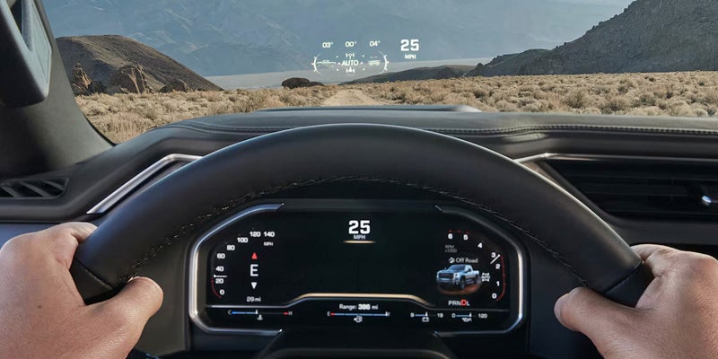 Close up view of the 2025 GMC Sierra HD front dashboard. front window and IntelliBeam from the driver's point of view