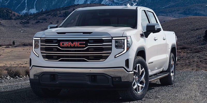 Front view of 2025 GMC Sierra 1500 driving on a mountain road