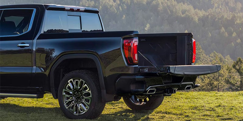 Rear side view of 2025 GMC Sierra 1500 with open truck bed