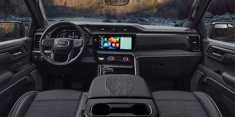 Wide view of the 2025 GMC Sierra 1500 front dashboard and front window from the rear passenger point of view